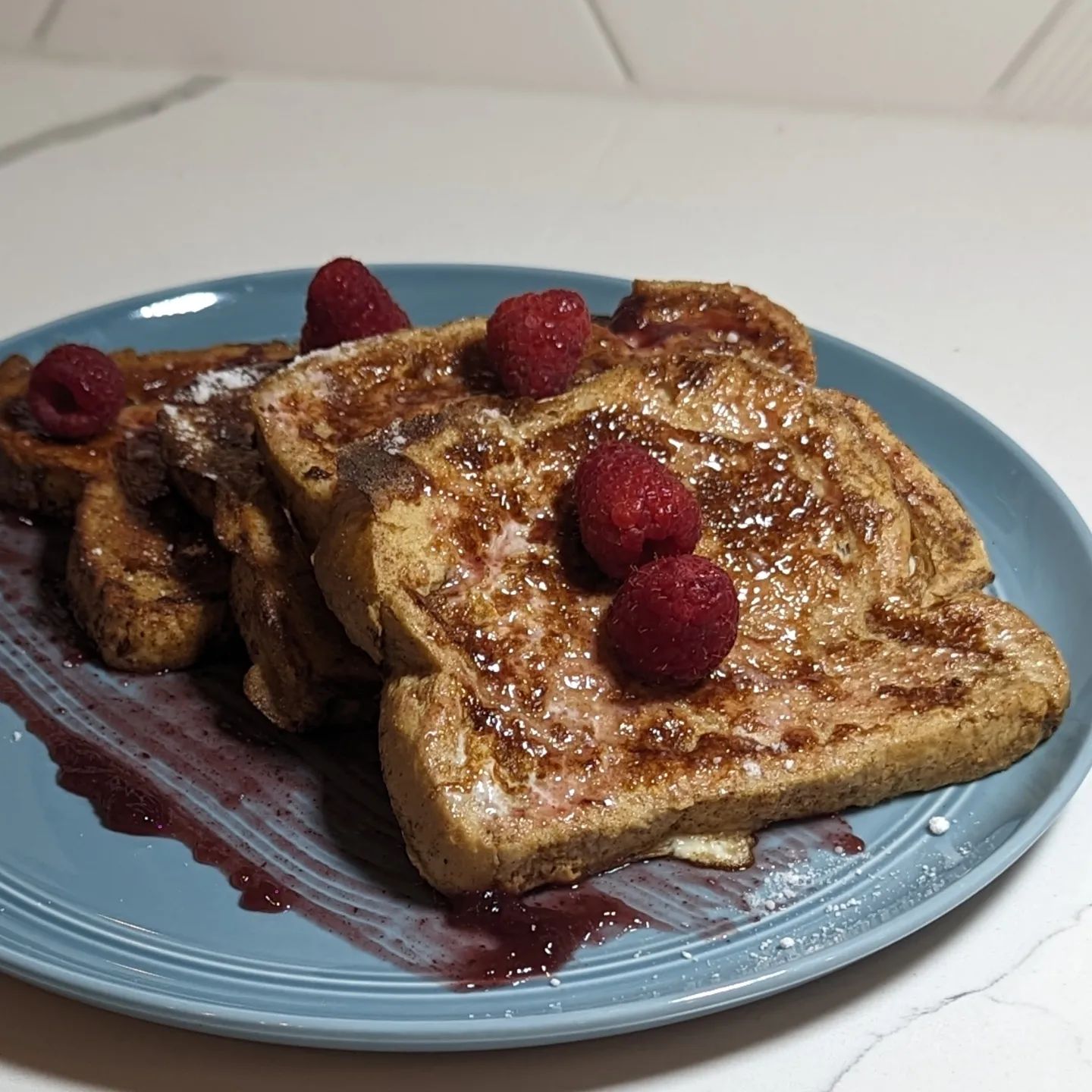 French Toast with fresh raspberries and a blackberry jam, served with a side of black pepper baconI used @carbonautbaking white bread for a low carb bread option, soaked in a mixture of eggs, half and half, @spiceology cinnamon and @molinavanilla Mexican vanilla. I brushed a layer of @skinnygirlbrand blackberry mule jan on the plate and on each slice. Then a light dusting of @swervesweetie confectioners sugar and some fresh raspberries topped it off. The pepper bacon is my home cured bacon coated in black pepper. This delicious breakfast was a great way to start the day waiting for the heavy rain from tropical storm Hillary. #frenchtoast #blackberry #raspberries #bacon #lowcarb #breakfast #sundaymornings #sandiego