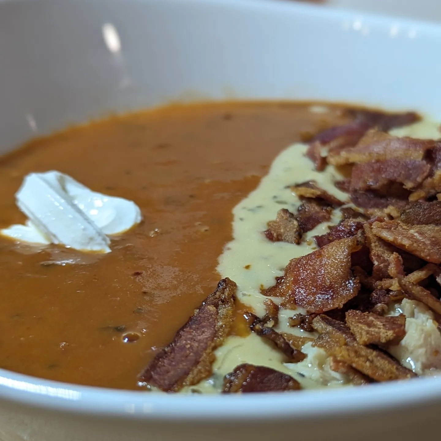 When it rains in San Diego, you eat soup! When you can't pick which soup you want, you eat both!I heated up these @eatpropergood soups, then garnished the chicken soup with some bacon, and the tomato soup with some sour cream. As the two come together, the acidity and richness blended perfectly and created a whole new flavor profile. #soupseason #tomatosoup #chickensoup #creamysoup #soupweather #rainydays #sandiegoweather #propergood