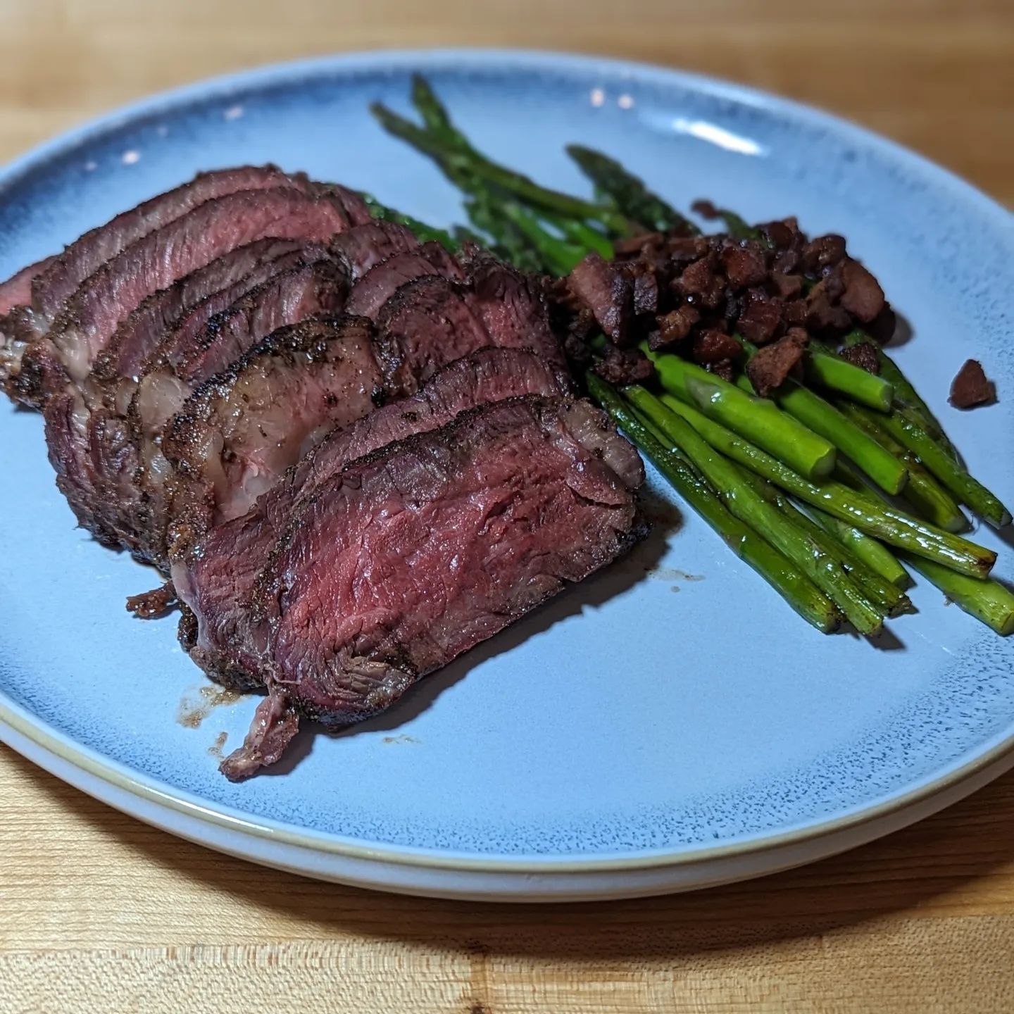 NY Strip & AsparagusReverse seared Thick cut NY strip smoked with @bearmountainbbq bourbon blend pellets. The steak was seasoned with @redmondrealsalt ancient grains sea salt and @neilsarap original beef rub. After a nice long smoke I seared the steak in the bacon fat rendered while cooking the bacon and asparagus. A touch of butter to finish the sear in the pan and it was set. #steakdinner #nystripsteaks #steakhouse #bearmountainbbq #asparagus #baconbits #perfectsteak #steak #fancydinner #dinnergoals #reversesear #mediumrare #steakgoals #healthydinner