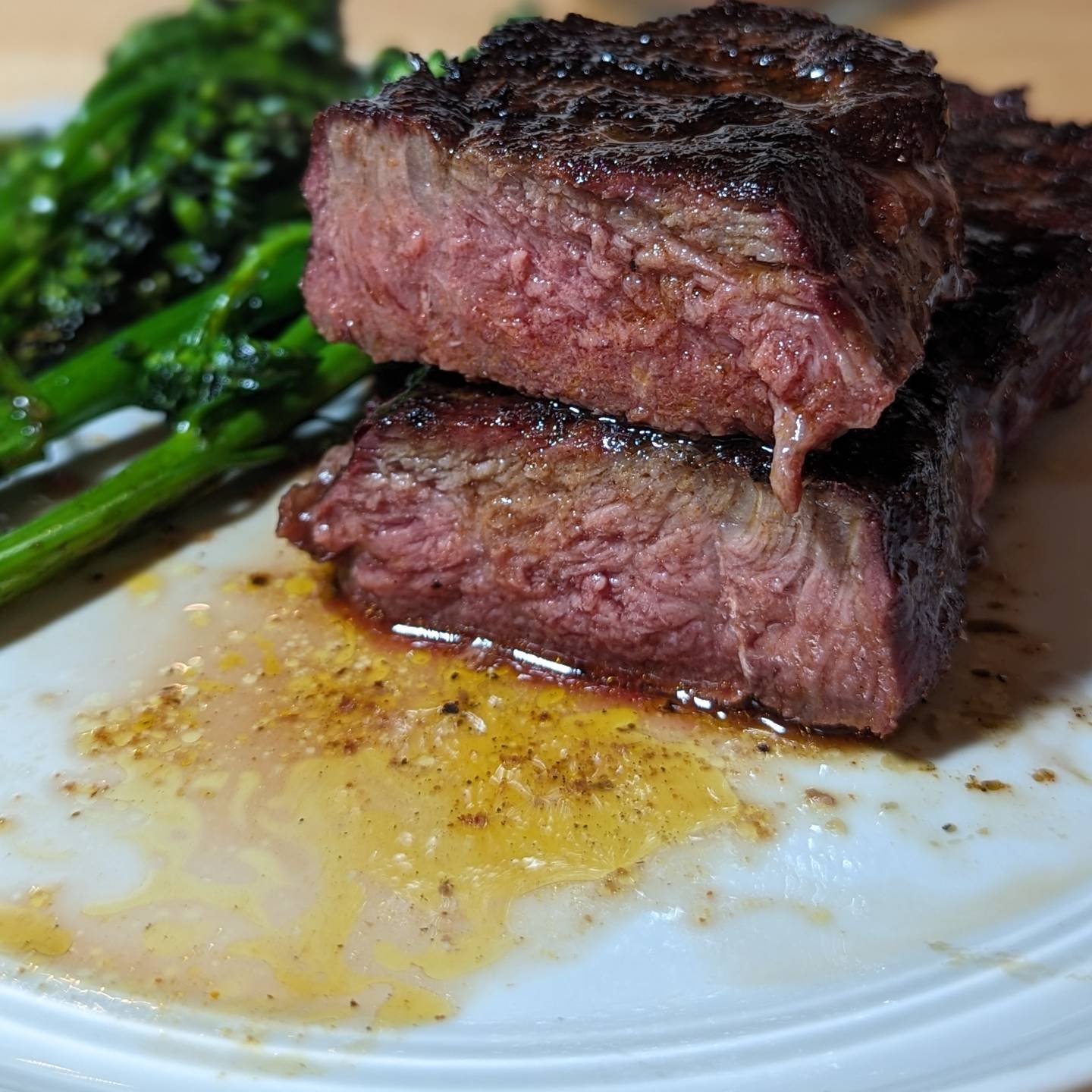 Steak & Broccolini This NY Strip was reverse seared. Seasoned liberally with @redmondrealsalt and @spiceology black magic, then smoked with @bearmountainbbq hickory wood to an internal temp of 120. I brought the steak inside and seared it with @hexclad over medium high heat and avocado oil. A bit of butter to finish and a slice of butter over the top while it rested. The broccolini was sauteed in a bit of oil and lightly seasoned with some salt.#steakdinner #reversesear #bearmountainbbq #steakhouse #juicysteak #blackenedsteak #smokedsteak #hickorysmoked #yodersmoker #meatandveggies #cleaneating